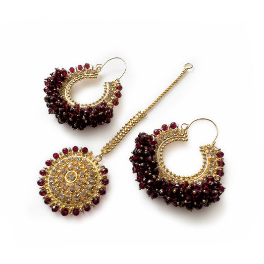 Maroon chand bali earrings and maang tikka set on a white background - Trending pakistani jewellery. 