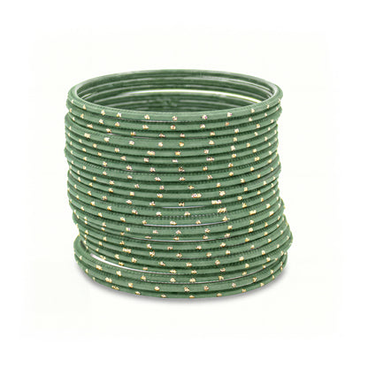 Mint green bangles with golden dots churi set arranged together showing slim elegant Indian jewellery design indian jewellery