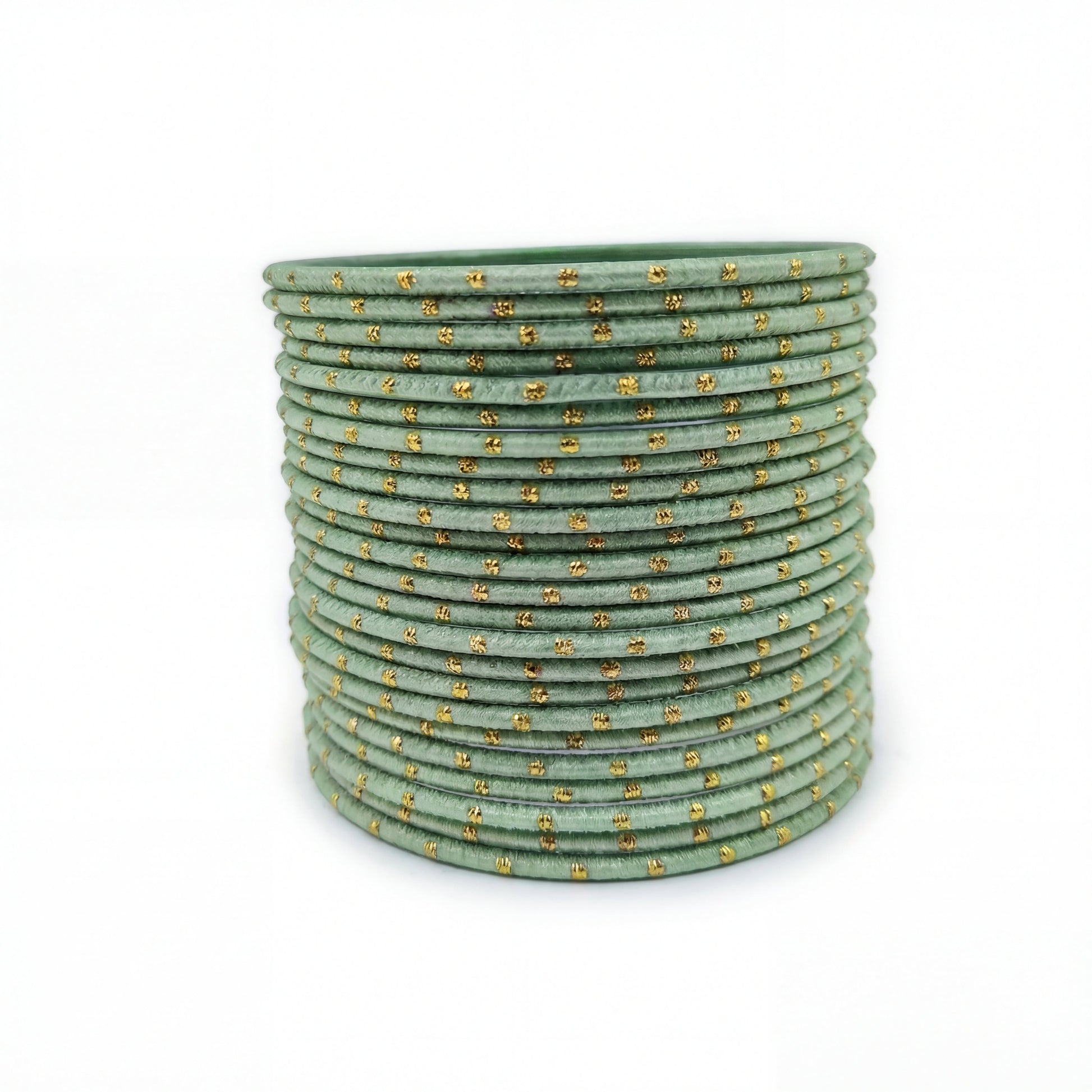 Mint green bangles with golden dots churi set arranged together showing slim elegant Indian jewellery design indian jewellery