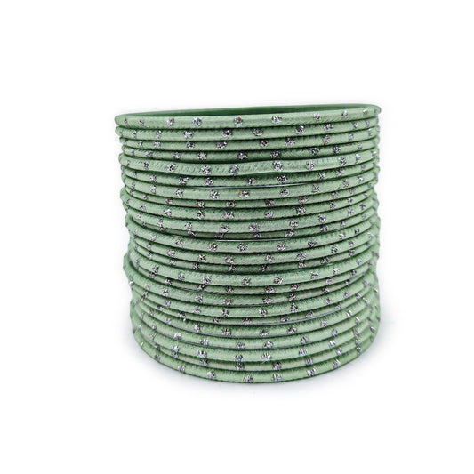 Mint green bangles with silver dots churi set arranged together showing slim elegant Indian jewellery design indian jewellery