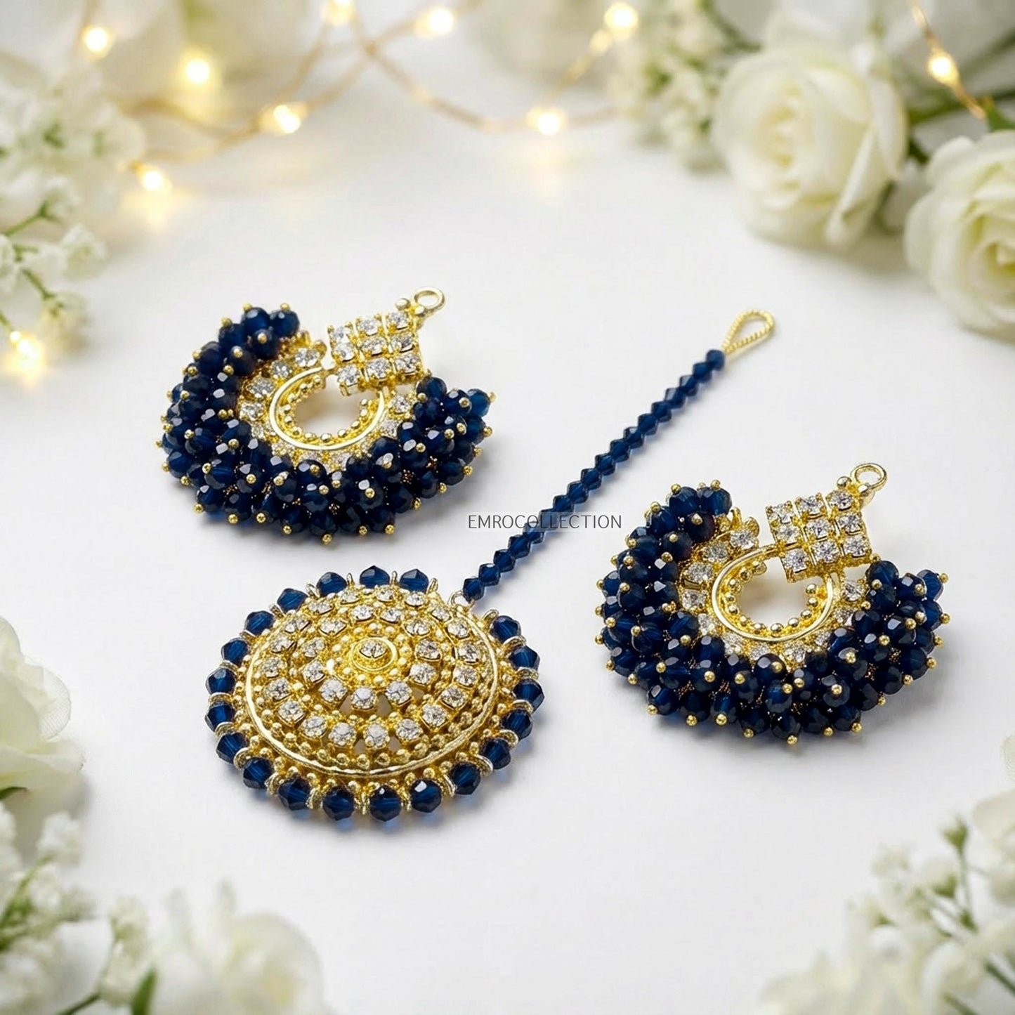 chand bali earrings tikka set on a white surface with flowers in the background - trending pakistani earrings tikka set