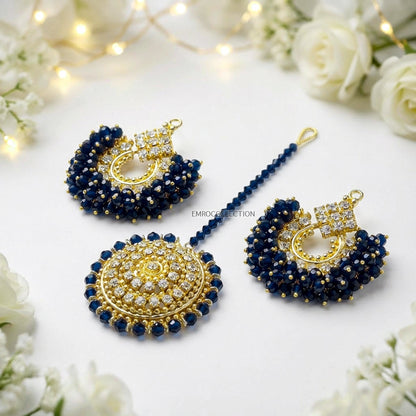 chand bali earrings tikka set on a white surface with flowers in the background - trending pakistani earrings tikka set
