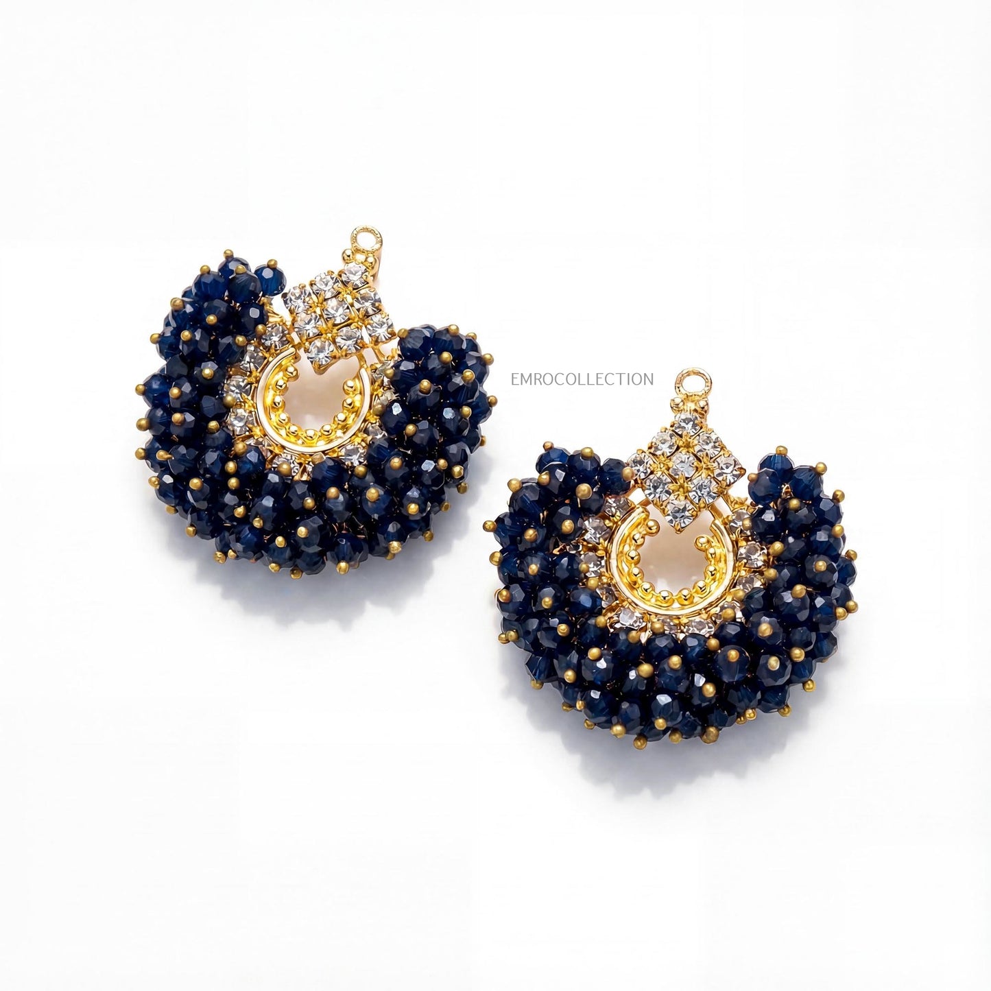 pair of gold and navy blue earrings on a white background