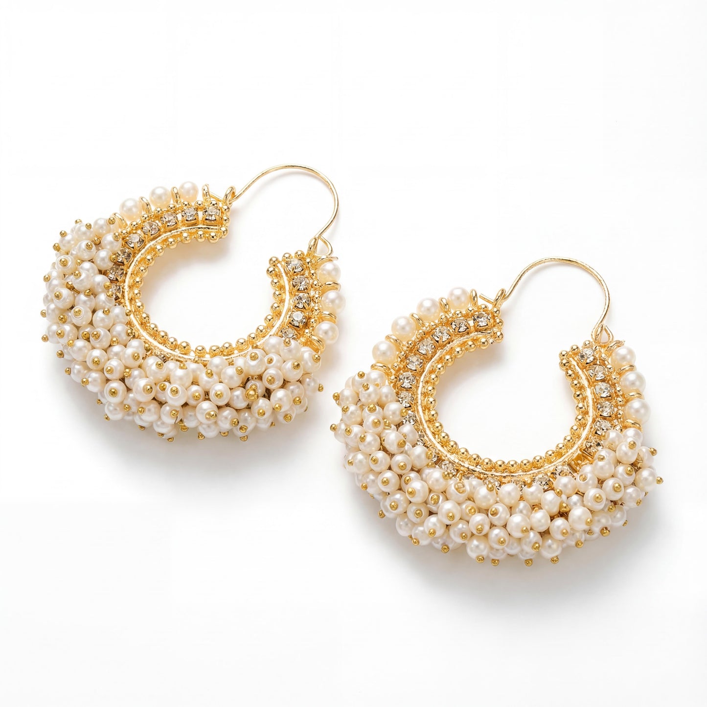 gold and pearl hoop earrings on a white background