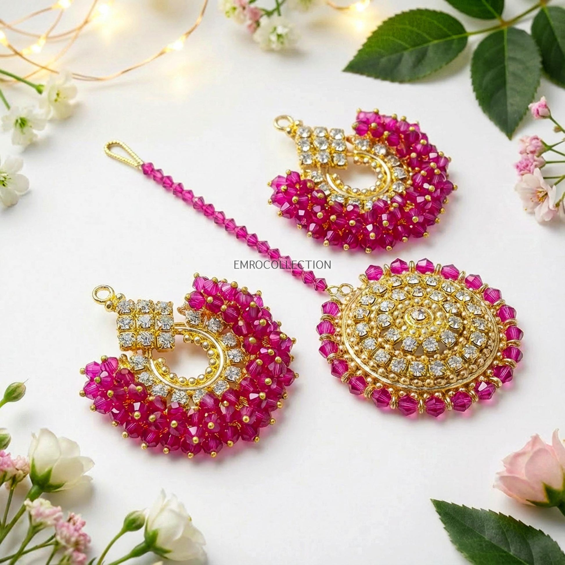 Shocking pink earrings tikka set with floral decorations on a white background - trending pakistani jewellery