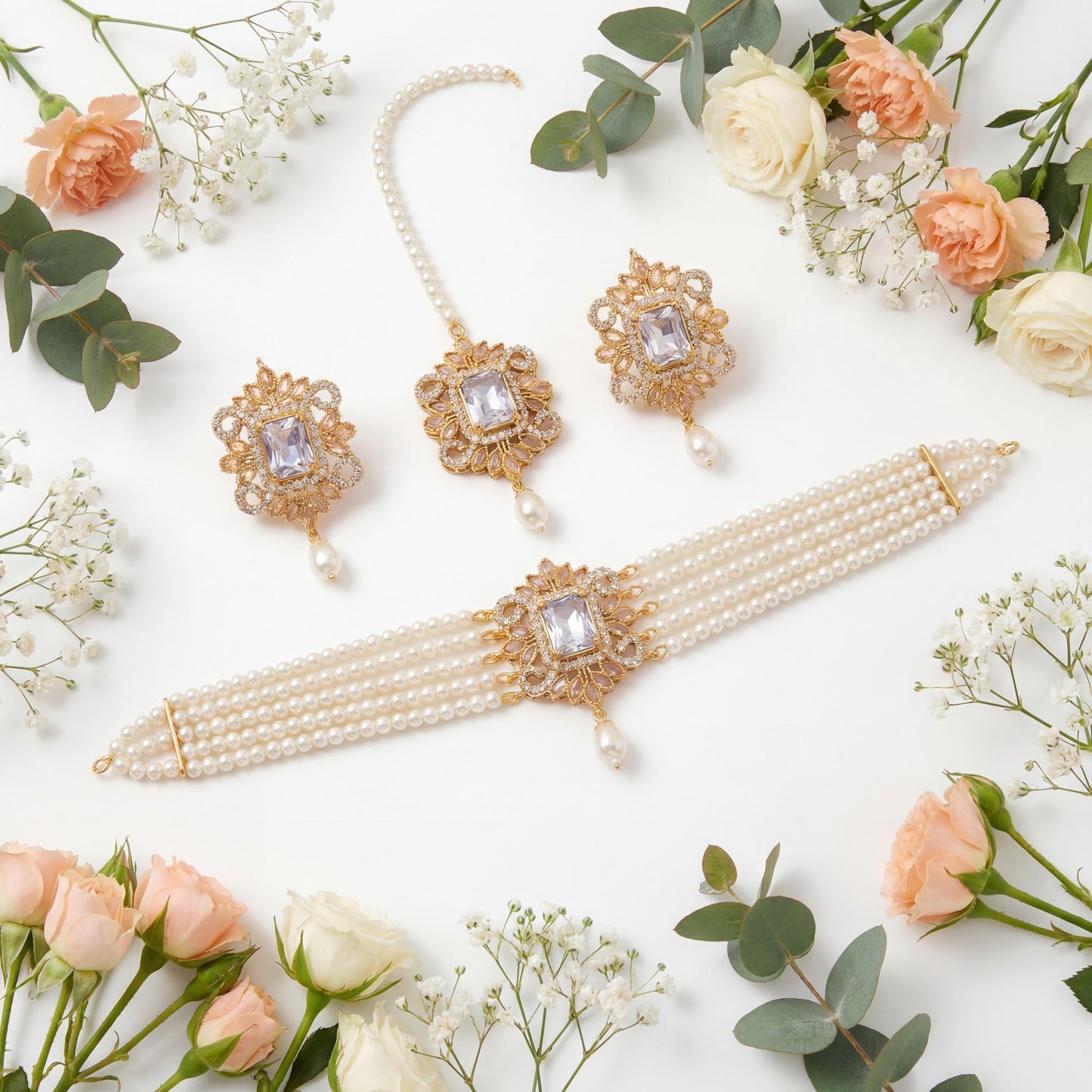 elegant off white pearl choker necklace set with matching tikka with flowers on a white background