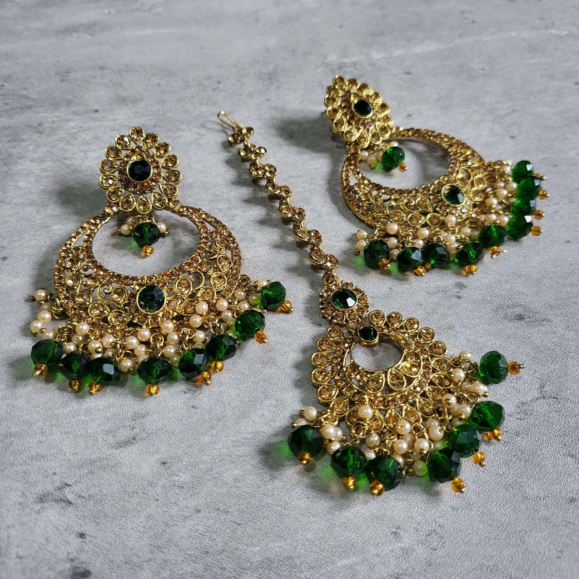 Close-up of Green Maang Tikka and Earrings Combo highlighting intricate emerald and gold craftsmanship
